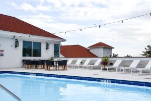 a patio with a table and chairs next to a swimming pool at Rod 'N' Reel Resort in Chesapeake Beach