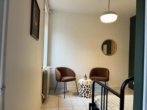 a hallway with two chairs and a table at La Estancia in Montsauche +7 photos