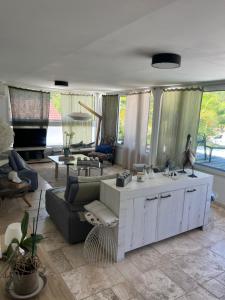 a living room with a couch and a table at Le Pelican in L'Ermitage-Les-Bains