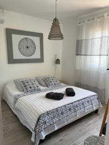 a bedroom with a bed with pillows on it at Le Pelican in L'Ermitage-Les-Bains