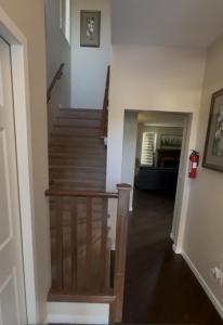 a hallway with a stairway with a stair case at Peace Home in Calgary