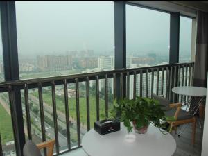 a balcony with a table and chairs and views of a city at Ibis Dujiangyan in Dujiangyan +13 photos