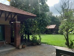 a pavilion with a green yard in the background at Teratak Assofiyya 4 Bilik in Sungai Petani