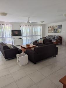 a living room with two couches and a coffee table at Yolanda - Burrum Heads- Beachfront - 3BR- Aircon in Burrum Heads