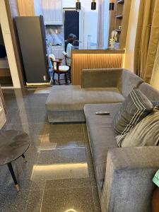 a living room with a couch and a table at Bungalow small peaceful house in Daanbantayan +17 photos