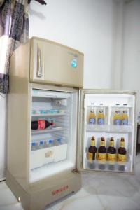 a refrigerator with its door open with drinks in it at SECRET MIRAGE Ella in Ella
