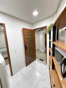 a hallway with a wooden door in a house at Centro de Vitoria in Vitória