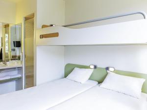 a bedroom with two bunk beds and a mirror at Ibis Budget Oviedo in Oviedo +61 photos