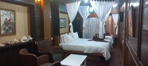 a hotel room with two beds and a window at Mangrove House Lanta Old Town in Ko Lanta