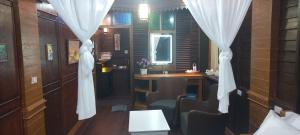 a room with a table and chairs and curtains at Mangrove House Lanta Old Town in Ko Lanta