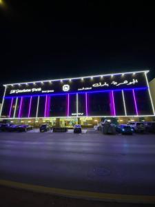 a large building with purple lights in a parking lot at الجوهرة بارك للشقق المخدومة 6 in Riyadh