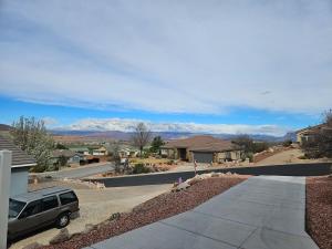 a car parked in a driveway with mountains in the background at Mountain View near Zion in Hurricane
