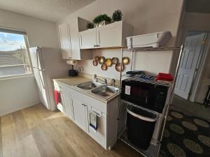 a small kitchen with a sink and a stove at Mountain View near Zion in Hurricane +30 photos