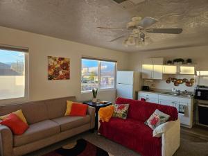 a living room with two couches and a kitchen at Mountain View near Zion in Hurricane