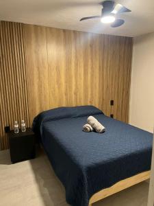 a bedroom with a bed with a towel on it at Hotel Urban Matamoros in Tepatitlán de Morelos