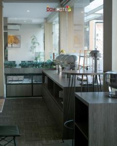 a kitchen with two tables and chairs in a room at DOM Hotel Jogja in Yogyakarta +25 photos