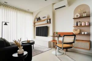 a living room with a couch and a chair at Velea Serviced Apartments & Suites in Siem Reap