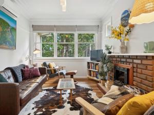 a living room with a couch and a fireplace at Pine Lodge in Blackheath