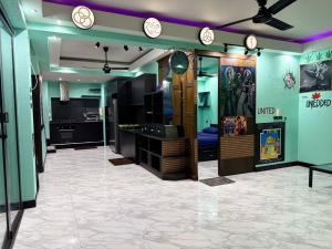 a room with a kitchen with clocks on the wall at เกาะช้าง พูลวิลล่า วิวทะเล 2 in Trat