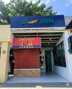 a store with a sign on the front of a building at D New Inn Mactan in Lapu Lapu City