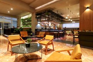 a lobby of a restaurant with chairs and a bar at St Isidro Suites Corporate Housing SPA & Wellness Center in Mexico City