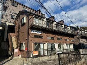 a building with a balcony on the side of it at 西山ハウス204 in Nagasaki