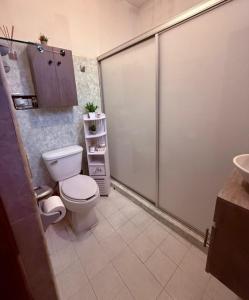a bathroom with a toilet and a sink at Serenity House Casa Huaxtla del Arenal in Huastla