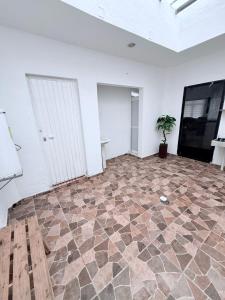 a room with a stone floor with a potted plant at Serenity House Casa Huaxtla del Arenal in Huastla +42 photos