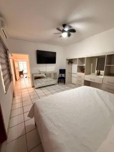 a bedroom with a bed and a flat screen tv at Serenity House Casa Huaxtla del Arenal in Huastla