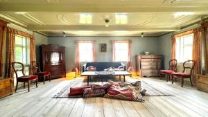 a living room with a couch and a table at Historic Farmhouse From 1848 in Hårby +33 photos