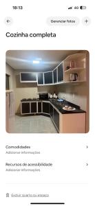 a screenshot of a kitchen with a stove and refrigerator at Apartamento Casa pontarolo in Guarapuava