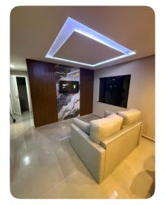 a living room with a couch and a tv at Apartamento Casa pontarolo in Guarapuava