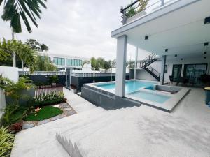 a swimming pool in the backyard of a house at Pool villa Cream Darin in Ban Hua Phrong
