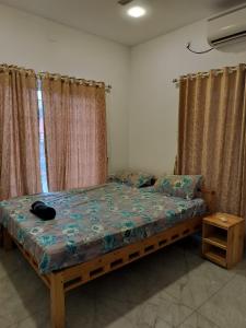 a bedroom with a bed with a wooden frame and curtains at Caesars fitness in Jāmb