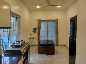a kitchen with a stove and a counter top at Caesars fitness in Jāmb