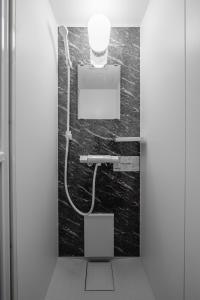 a bathroom with a sink and a light on the wall at Hills Niseko C in Niseko