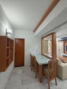 a dining room with a table and chairs at Utsavam Hotel Apartments in Guruvāyūr