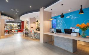 a lobby of a store with a blue wall at 宜必思昆明火车站酒店Ibis Kunming Railway Station in Kunming