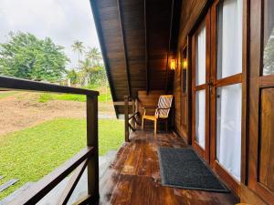a porch of a house with a chair and a table at Soluna Cove luxury Cabanas Hikkaduwa in Hikkaduwa