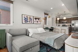 a bedroom with a bed and a couch and a kitchen at Rooftop Retreat with Workspace and BBQ in Denver