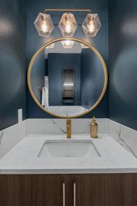 a bathroom with a sink and a mirror at Rooftop Retreat with Workspace and BBQ in Denver +35 photos