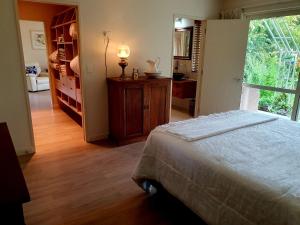 a bedroom with a bed and a large window at Lily Pad Apartment in Motueka