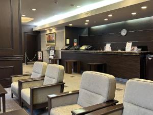 a waiting room with chairs and a reception counter at Hotel Route-Inn Dai-ni Suwa Inter in Suwa