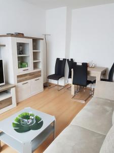 a living room with a couch and a table at Apartment am Kaiserplatz in Düren - Eifel