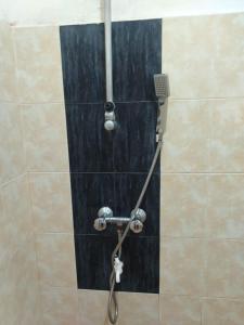 a shower with a shower head in a bathroom at The Heritage Hotel in Polonnaruwa