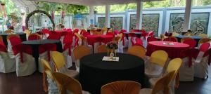 a group of tables and chairs with red and yellow tables at The Heritage Hotel in Polonnaruwa +7 photos