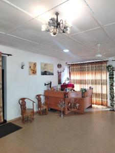 a living room with a table and chairs and a chandelier at The Heritage Hotel in Polonnaruwa