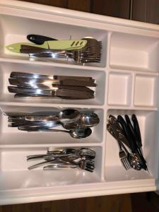 a drawer filled with silver utensils in a refrigerator at notre petit paradis in Winnenden