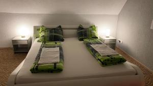 a large bed in a room with two night stands at notre petit paradis in Winnenden