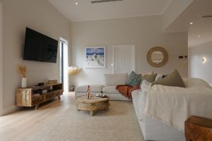 a living room with a couch and a table at The Dunes in Island Beach